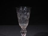 a close up of a wine glass on a table with a black background