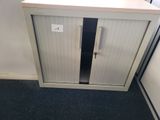 a white cabinet with a door and a black door