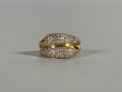 an image of a gold and diamond ring on a white surface