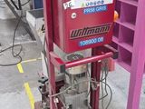 a machine that is sitting on the floor next to a shelf