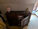 a bed and a dresser in a room with a floral wallpaper