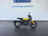 an image of a motorcycle parked in front of an auction sign