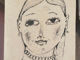 drawing of a woman ' s face on a piece of paper