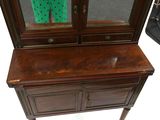 a small wooden cabinet with a mirror on top of it