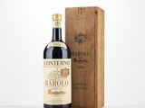 a bottle of wine sitting next to a wooden box