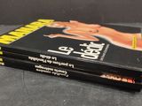 two books on a black table with a black background