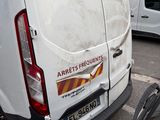 a white van parked in a parking lot next to a building