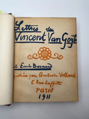 an open book with an orange and blue design on it