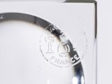 a close up of a glass with a stamp on it