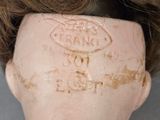 a close up of a doll ' s head with writing on it