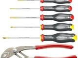 six different types of screwdrivers and pliers in a row