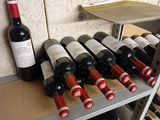 many bottles of wine sitting on a shelf in a wine cellar
