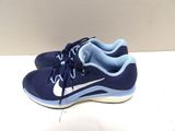 blue nike running shoes with white soles on a white surface