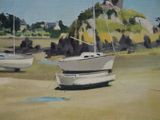 two boats that are sitting in the sand