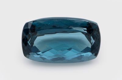 a blue green tourmaline gems on a white background