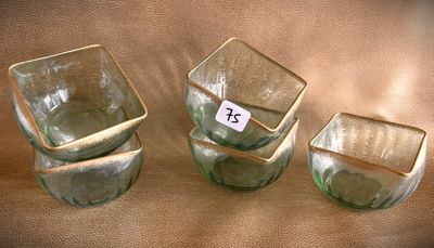 three glass cups sitting on a table with a price tag on them