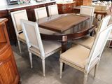 a large dining room table and chairs in a store