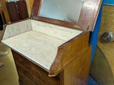 a wooden chest with a mirror on top of it