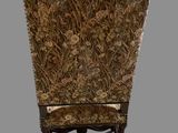 an image of a chair with a floral upholstered back and legs