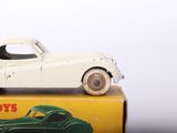 a white toy car sitting on top of a box