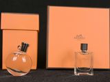 three bottles of perfume sitting next to each other on a table