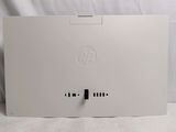 the back of a white hp desktop computer sitting on top of a white sheet