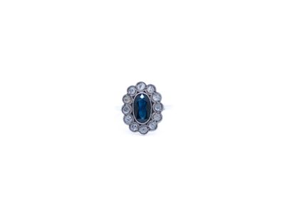 a close up of a ring with a blue stone in it