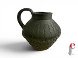 a green vase that is sitting on a white surface
