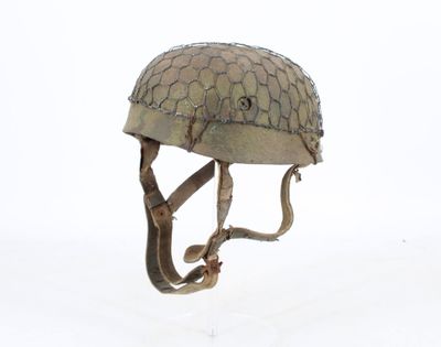 a helmet that is sitting on the ground in the snow
