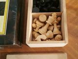 a box of chess pieces and a box of chess pieces on a table