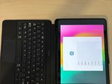 two laptops sitting next to each other on a table