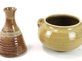 two vases sitting next to each other on a white surface