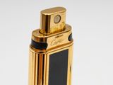 an image of a gold lighter with a black cover on it