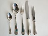 four forks, a spoon, and a knife on a table