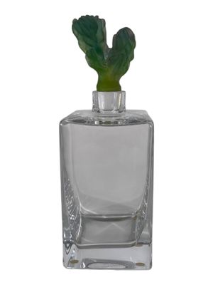 a close up of a glass vase with a plant inside of it