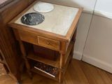 a small table with a marble top in the corner of a room