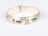 a close up of a silver bracelet with elephants on it