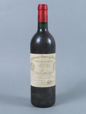 an old bottle of wine sitting on top of a table