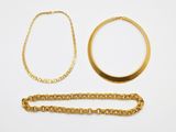 a collection of gold jewellery including a necklace, bracelet and ring