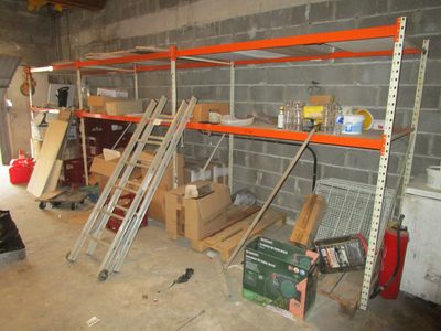 a room with a lot of shelves and tools in it