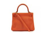 a small orange leather handbag on a white background