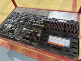many different tools in the tray on the table