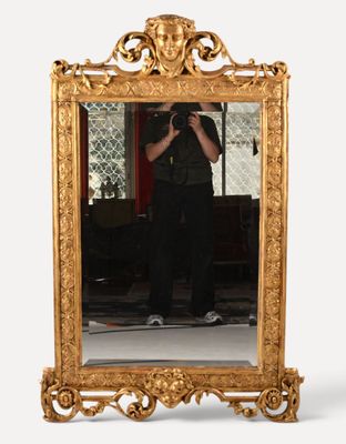 a man taking a picture of himself in a mirror