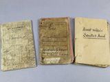 three old books sitting on top of a table next to each other
