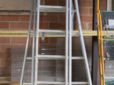 many ladders that are sitting in a room