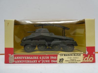 toy army vehicle in plastic box on white surface with red and yellow background