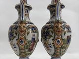 two vases are sitting on a white surface with a white background