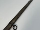 an old gun with a metal handle on a white surface