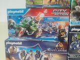 a lot of playmobil action toys on the table