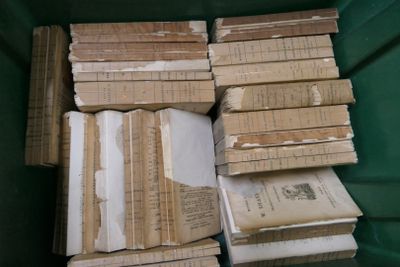 many old books stacked on top of each other